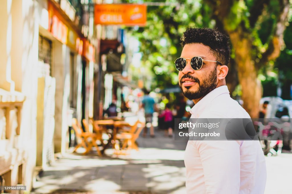 Portrait of a man looking back on a street in porto alegre