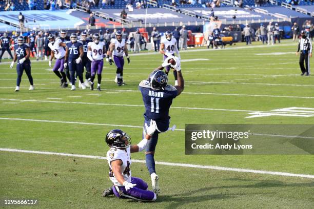 Wide receiver A.J. Brown of the Tennessee Titans catches a 10-yard touchdown pass against cornerback Marlon Humphrey of the Baltimore Ravens during...