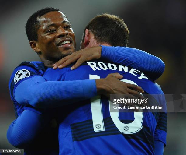 Patrice Evra congratulates Wayne Rooney of Manchester United after scoring from the penalty spot during the UEFA Champions League Group C match...