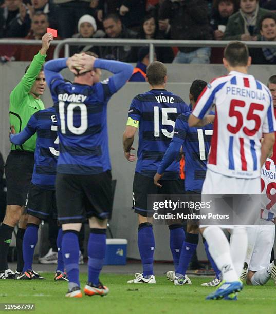 Nemanja Vidic of Manchester United is sent off by referee Felix Brych during the UEFA Champions League Group C match between Otelul Galati and...