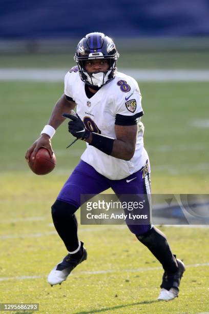Quarterback Lamar Jackson of the Baltimore Ravens carries the ball for yardage during the fourth quarter of their AFC Wild Card Playoff game against...