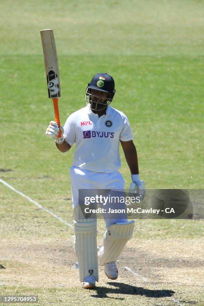 Rishabh Pant of India celebrates after reaching his half century during day five of the 3rd Test match in the series between Australia and India at...