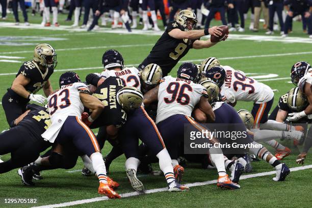 Drew Brees of the New Orleans Saints dives in the end zone to score a one yard touchdown against the Chicago Bears during the fourth quarter in the...