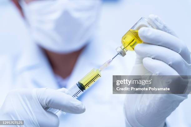 covid-19 vaccine, close up of doctor, nurse, scientist, researcher hand in gloves holding flu, measles, coronavirus vaccine disease preparing, medicine and drug concept. - measles hand stock pictures, royalty-free photos & images