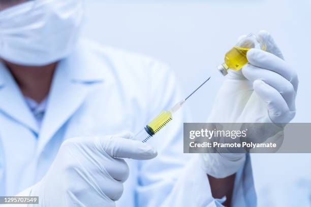 close up of doctor, nurse, scientist, researcher hand in gloves holding flu, measles, covid-19 vaccine disease preparing for human clinical trials vaccination shot, medicine and drug concept. - measles hand stock pictures, royalty-free photos & images