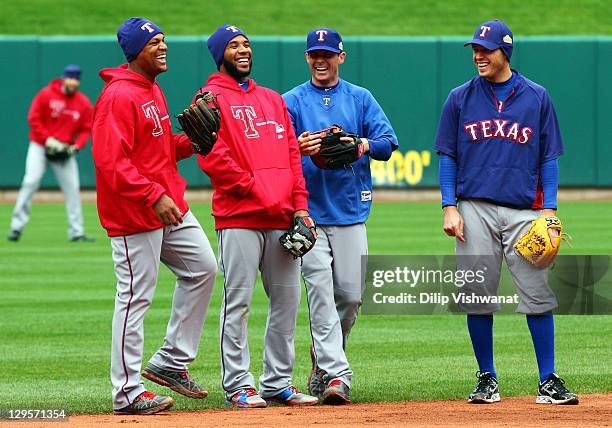 Adrian Beltre, Elvis Andrus, Michael Young and Ian Kinsler stand in the field during batting practice and at Busch Stadium on October 18, 2011 in St...