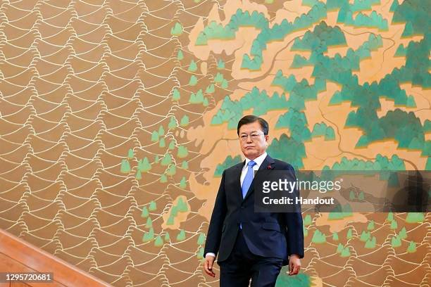 In this handout image provided by South Korean Presidential Blue House, South Korean President Moon Jae-in walks for his New Year's speech at the...
