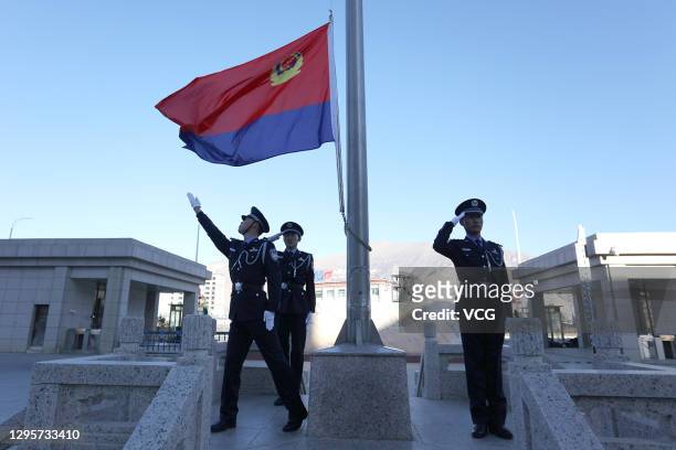 Policemen of Tibet General Station of Immigration Inspection attend a flag-raising ceremony to mark the Chinese people's police day on January 10,...