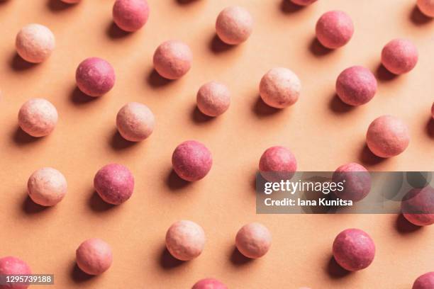 pink blush and mineral face powder on pastel beige background. banner. trendy colors. makeup. cosmetic products. tonal foundation. - pale pink stock pictures, royalty-free photos & images