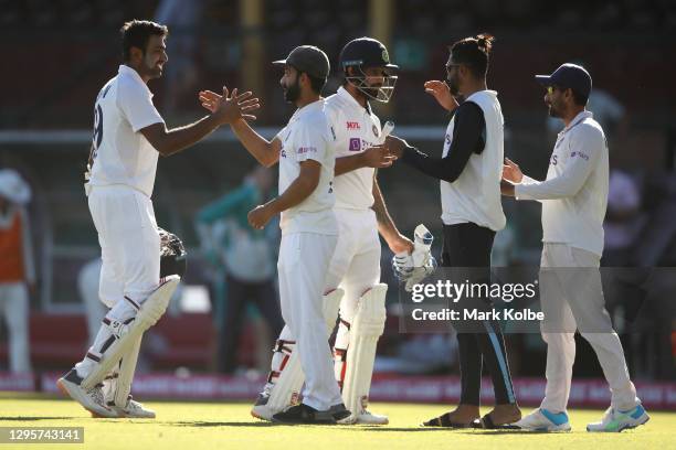 Ravichandran Ashwin, Ajinkya Rahane, Hanuma Vihari and Mohammed Siraj of India celebrate securing a draw during day five of the Third Test match in...