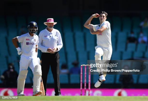 Pat Cummins of Australia bowls past Ajinkya Rahane and umpire Paul Wilson during day five of the Test match in the series between Australia and India...
