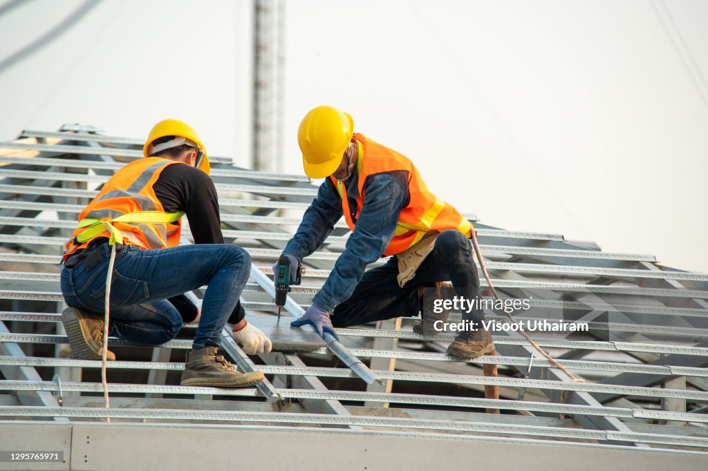 Roofer worker install new roof,Construction Industry,Roofing tools.