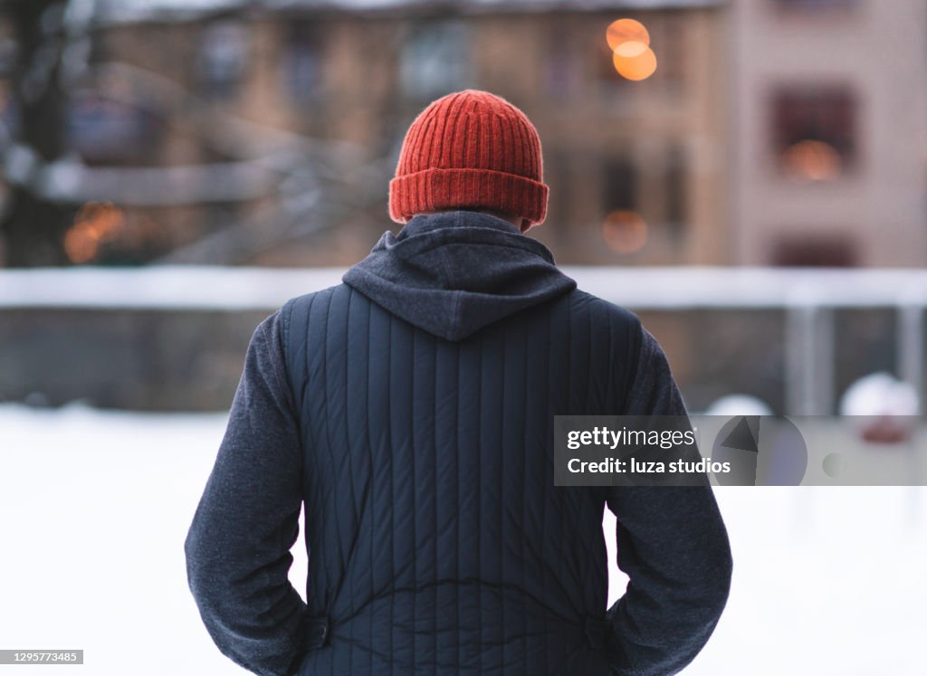 Behind a man Walking through snow