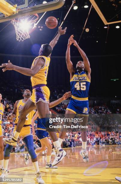 Chuck Person, Power Forward for the Indiana Pacers makes a jump shot to the basket as James Worthy of the Los Angeles attempts to block during their...