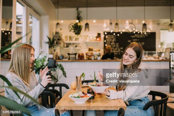 teenager influencers making a video at vegan cafe - generation z food stock pictures, royalty-free photos & images