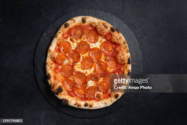 neapolitan pizza on black background - pepperoni pizza stock pictures, royalty-free photos & images