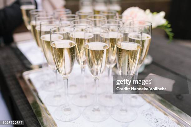 filled champange flutes ready to drink - prosecco stock pictures, royalty-free photos & images