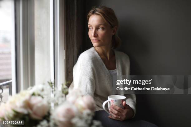 portrait of a woman at home - cardigan sweater stock pictures, royalty-free photos & images