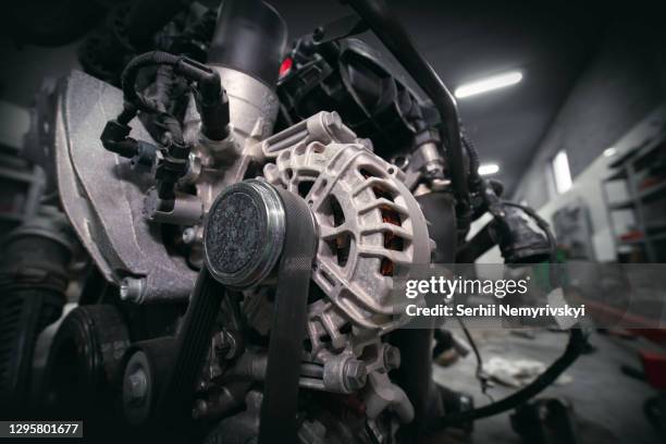 the engine, the motor from the passenger vehicle, is located separately from the car. removal and replacement. timing rollers, pipe tensioners. sensors and wires. generator. car service and work - pipe replacement stock pictures, royalty-free photos & images