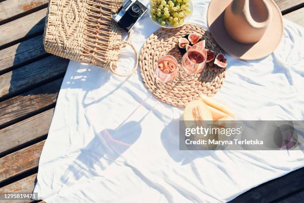 picnic at the pier near the water. - picnic blanket top view stock pictures, royalty-free photos & images