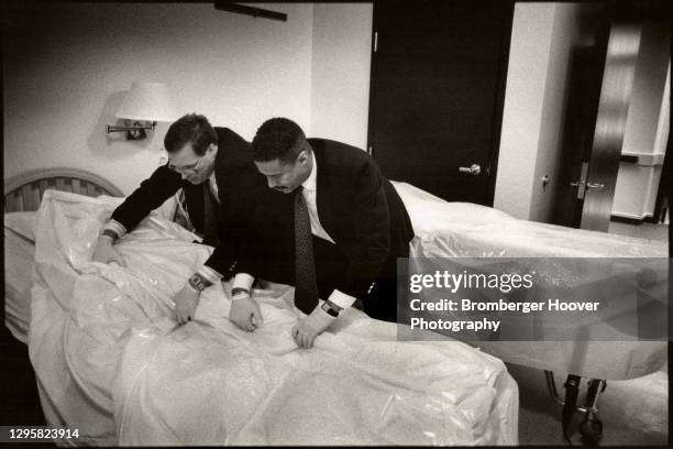 At the Bailey-Boushay House, two unidentified coroners prepare AIDS patient George Hill's body for transport to the mortuary, Seattle, Washington,...