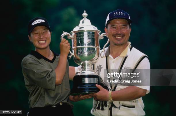 Se Ri Pak of South Korea holds the USGA trophy aloft with her father Joon Chul Pak after winning the 48th United States Women's Open Championship...