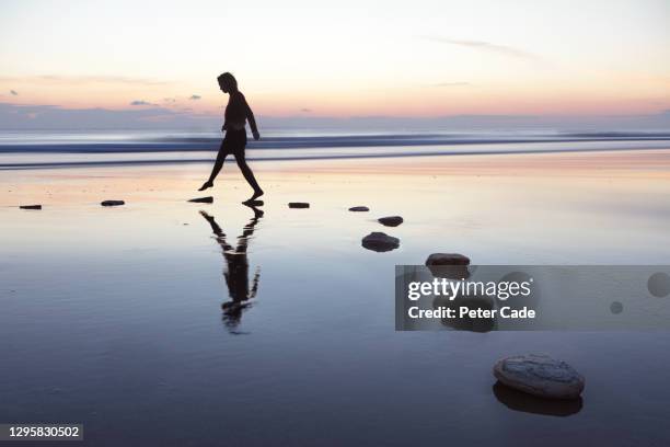 stepping stones over water - fare un passo foto e immagini stock