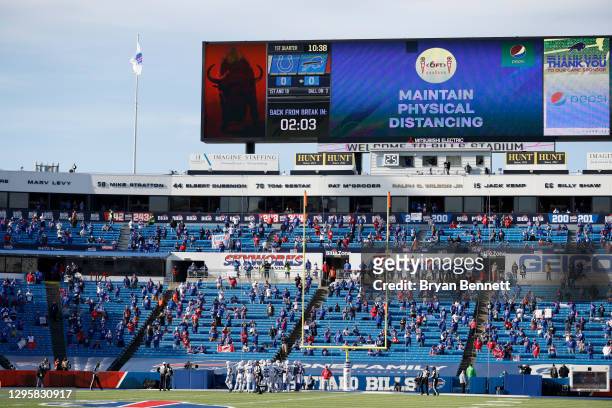 View of the scoreboard displaying COVID-19 protocol during the first quarter of an AFC Wild Card playoff game between the Buffalo Bills and the...