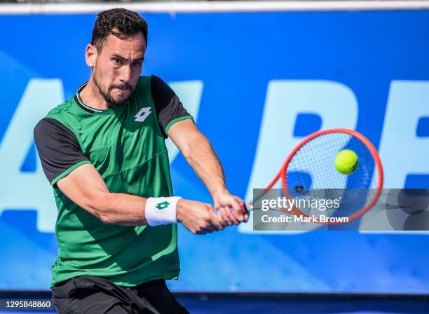 Gianluca Mager of Italy plays a backhand against Christian Harrison of USA during the Quarterfinals of the Delray Beach Open by Vitacost.com at...