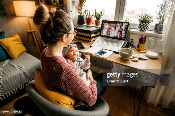 working from home and nursing cute baby - leanincollection ストックフォトと画像