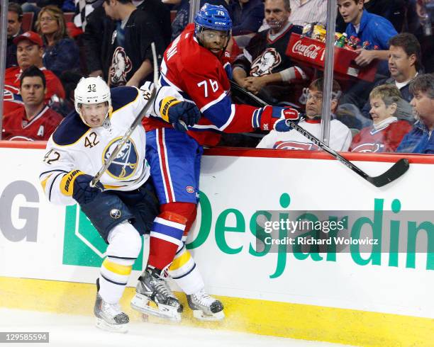 Nathan Gerbe of the Buffalo Sabres body checks P.K. Subban of the Montreal Canadiens during the NHL game at the Bell Centre on October 18, 2011 in...