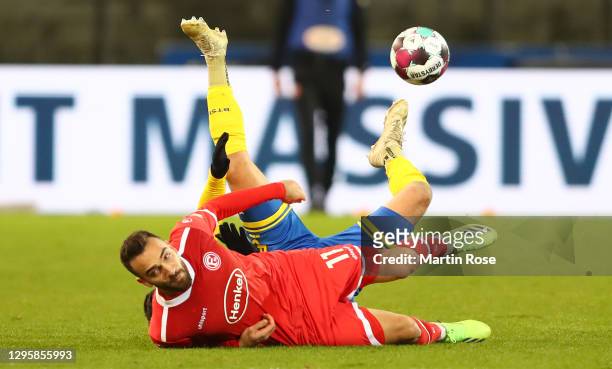 Kenan Karaman of Duesseldorf is challenged by Jannis Nikolaou of Braunschweig during the Second Bundesliga match between Eintracht Braunschweig and...