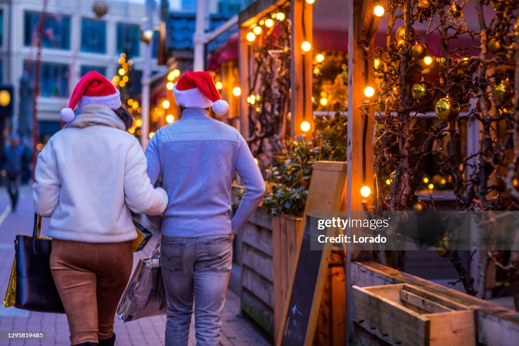 A mixed race couple enjoying the warm cafe culture in a winter bar