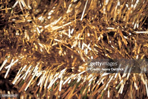 gold tinsel - tinsel stock pictures, royalty-free photos & images