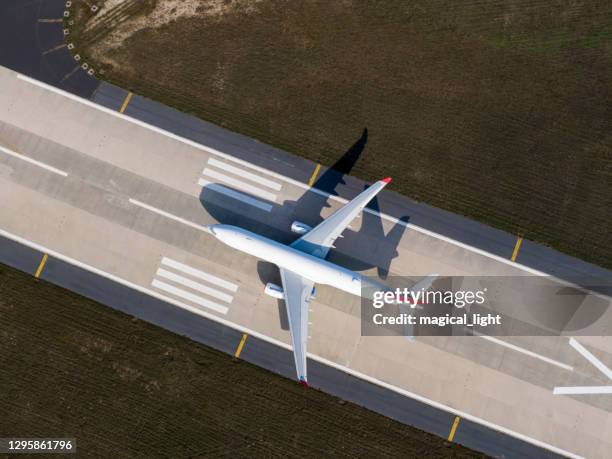 aerial drone photo of air planes as seen from above docked in airport space - airport cargo stock pictures, royalty-free photos & images