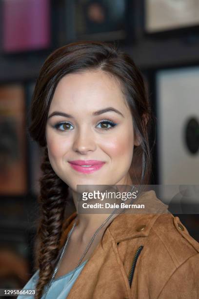Actress Hayley Orrantia poses for a portrait at a record store with a record turn table on October 26, 2014 in Hollywood California.