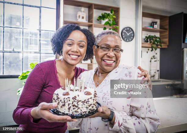 celebrating grandma's birthday - grandma daughter stock pictures, royalty-free photos & images