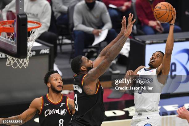 De'Anthony Melton of the Memphis Grizzlies shoots over Andre Drummond of the Cleveland Cavaliers during the second quarter at Rocket Mortgage...