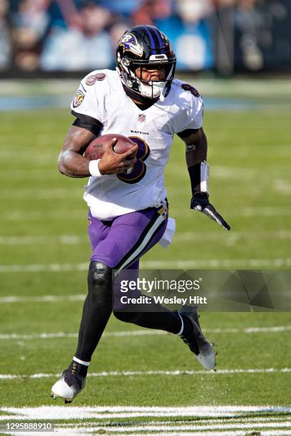 Quarterback Lamar Jackson of the Baltimore Ravens runs the ball during their AFC Wild Card Playoff game against the Tennessee Titans at Nissan...
