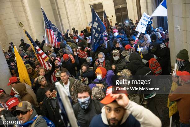 Protesters supporting U.S. President Donald Trump gather near the east front door of the U.S. Capitol after groups breached the building's security...