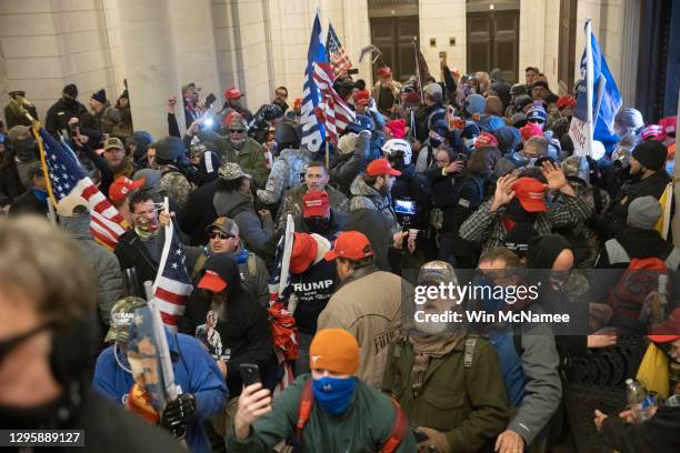 Protesters supporting U.S. President Donald Trump gather near the east front door of the U.S. Capitol after groups breached the building's security...