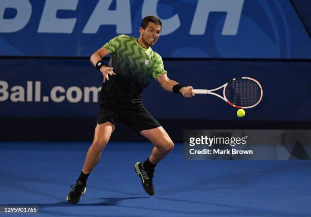 Cameron Norrie of Great Britain returns the shot to Frances Tiafoe of the United States during the Quarterfinals of the Delray Beach Open by...