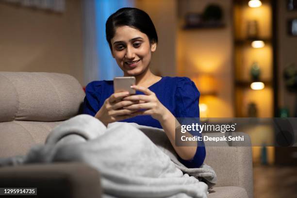 young woman at home - stock photo - female sitting on sofa stock pictures, royalty-free photos & images