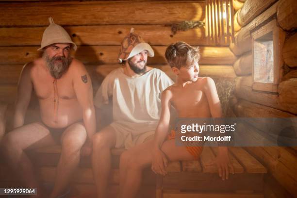 bath spa treatments at russian sauna. healthy family leisure - young boy in sauna stock pictures, royalty-free photos & images