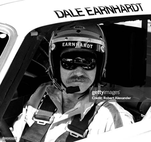 Driver Dale Earnhardt Sr. Sits in his car at the Daytona International Speedway prior to the start of the 1980 Daytona 500 on February 17, 1980 in...