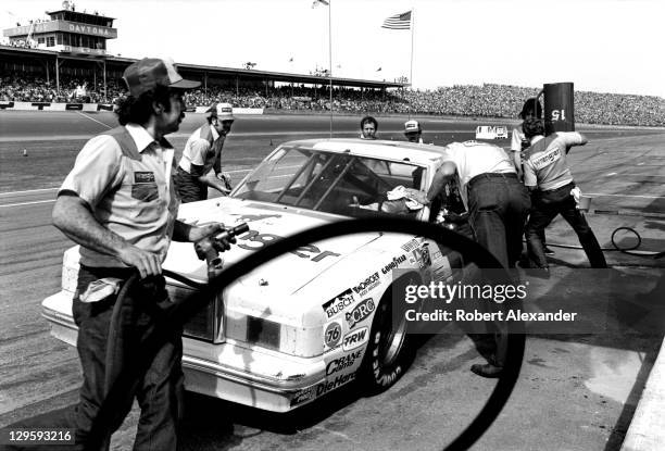 Driver Dale Earnhardt Sr., driving the No. 15 car owned by Bud Moore, makes a pit stop during the 1982 Firecracker 400 at the Daytona International...