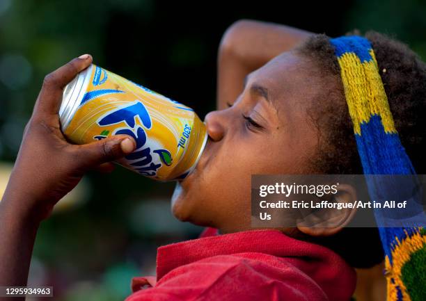 Boy drinking fanta can, East New Britain Province, Rabaul, Papua New Guinea on October 1, 2009 in Rabaul, Papua New Guinea.