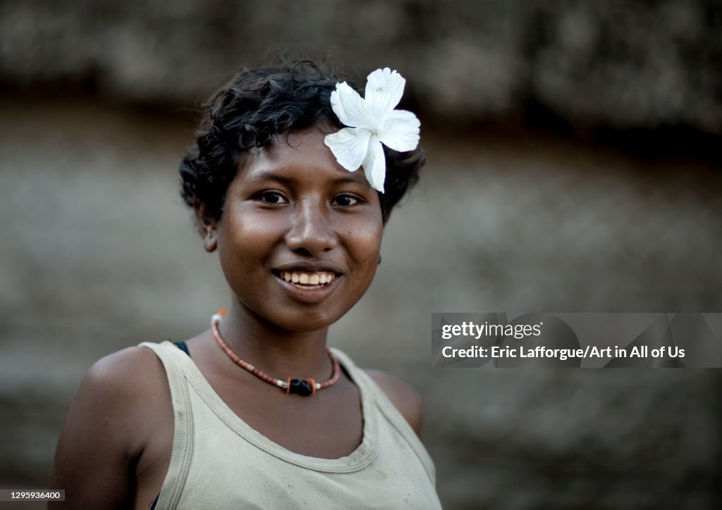 Smiling girl with flowers in the hair, Milne Bay Province, Trobriand Island, Papua New Guinea...