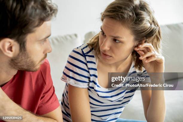 young couple talking with each other - couple serious bildbanksfoton och bilder