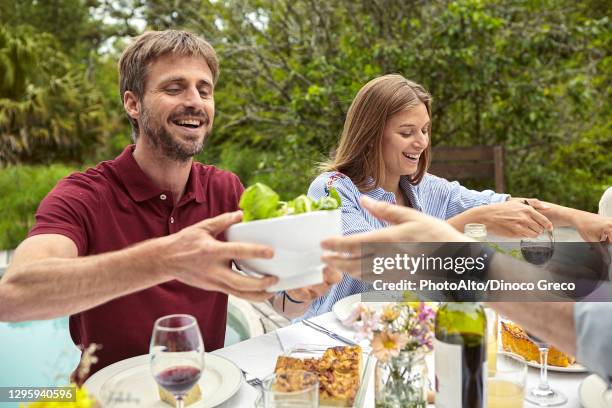 happy family having meal - father in law stock pictures, royalty-free photos & images